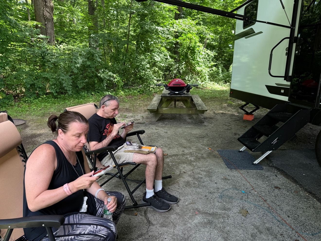 Chairs set out beside the fifth wheel at a site