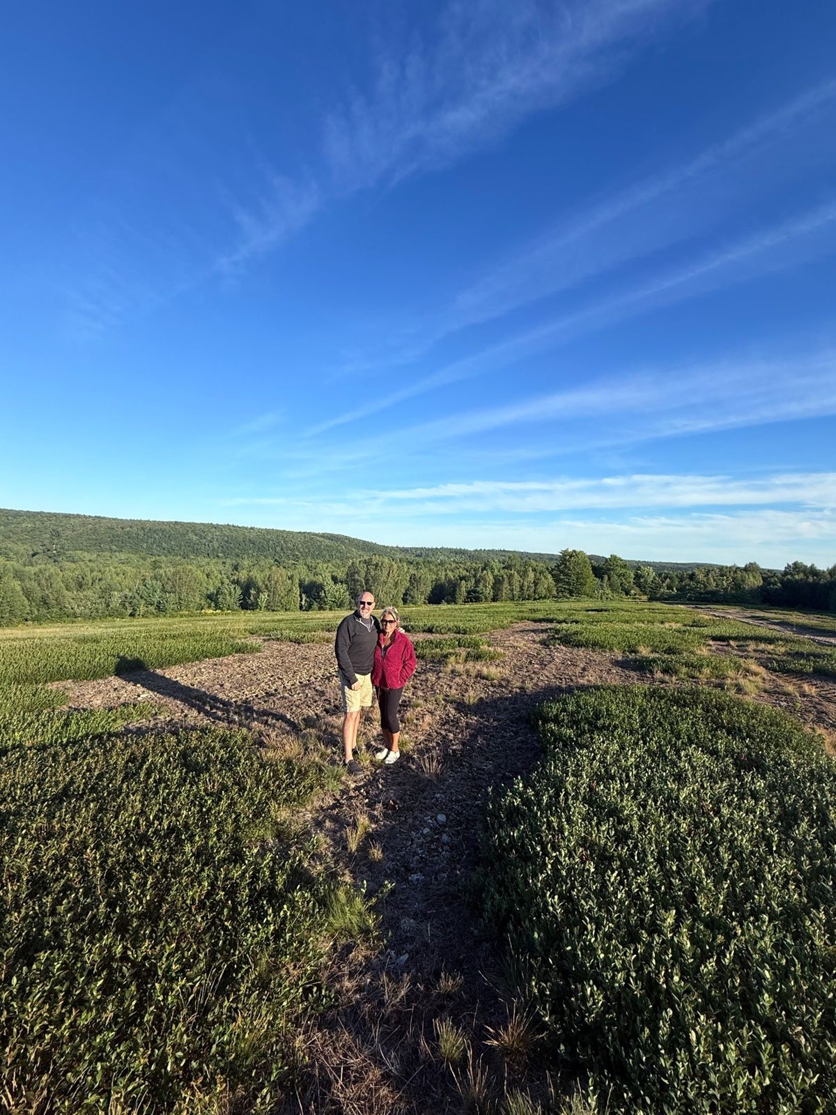 The two of us standing in an open field on a bright day