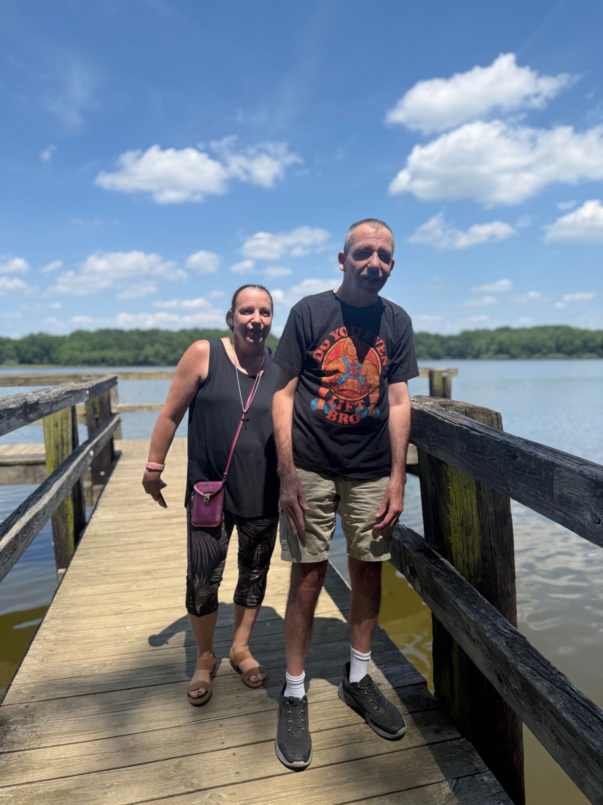 J and J standing on a pier over the water