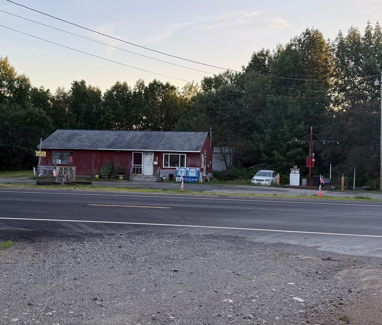 A small roadside store with a gas sign